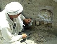 Excavating a sandstone Stele or wall carving from the wall of an ancient temple