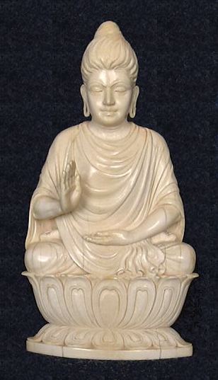 Unusual rendering of Ghanadaran style Shakyamuni Buddha exquisitely carved in ivory seated in 'Gesture of Fearlessness' or 'blessing'  or abhaya mudra from early 20th century - (7 in. tall)