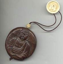 Antique signed Japanese Inro with Buddhas and ivory ojimi with inset garnet